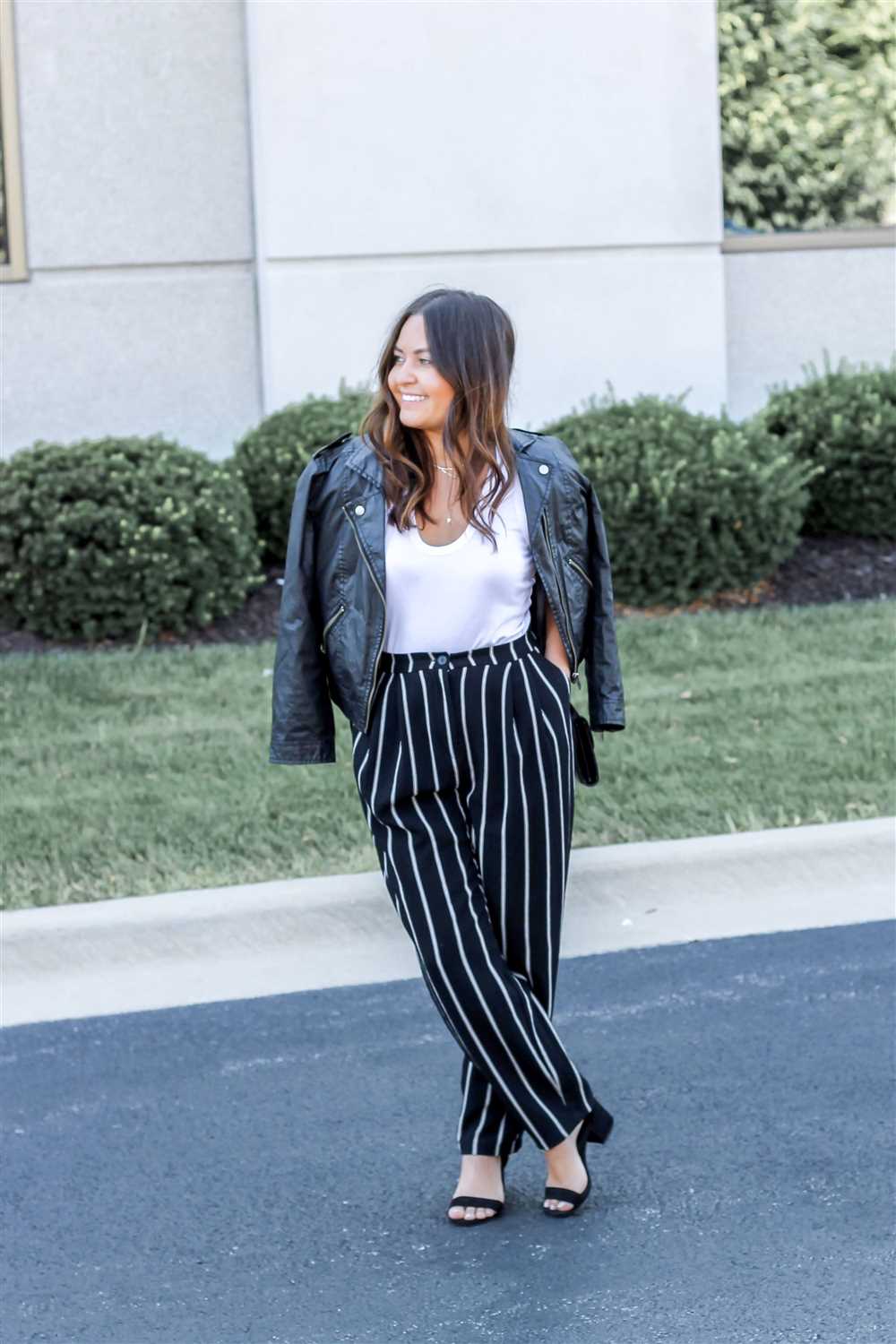 Pairing black and white striped pants with different tops and accessories